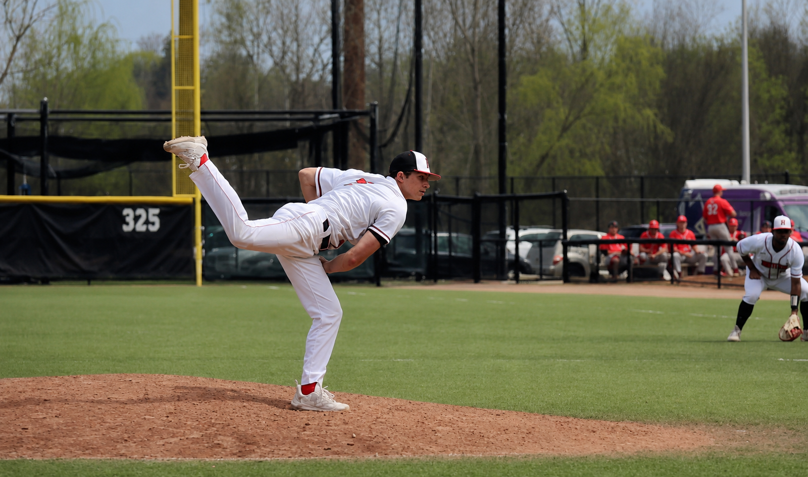 Jack finishing his pitching motion on the mound with full follow-through