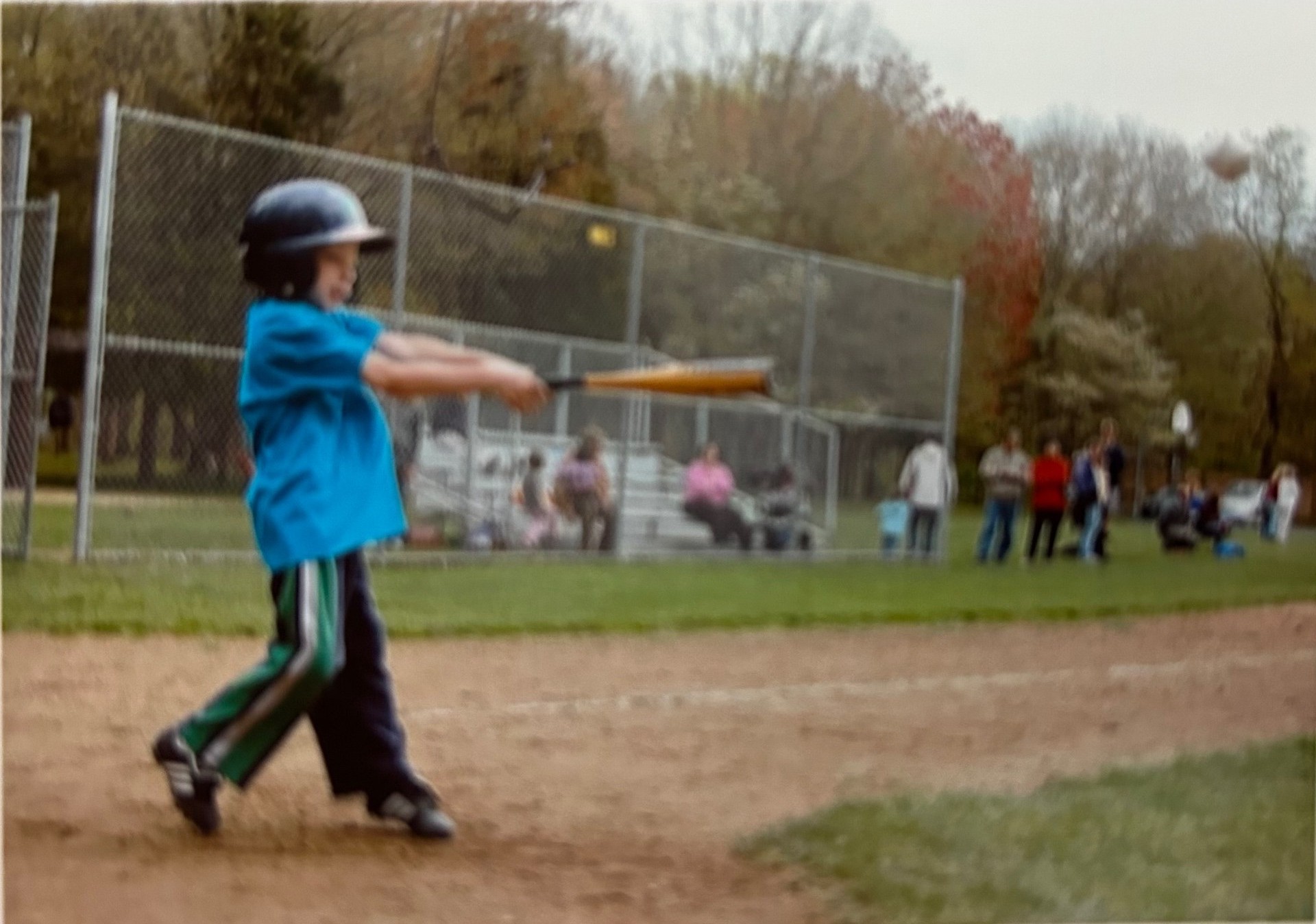 Young Jack at the plate, mid-swing with an aluminum bat
